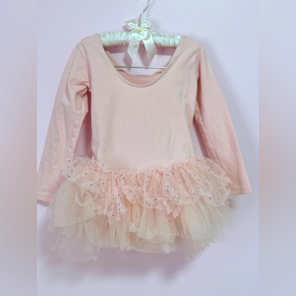 A ballet dress for a four-year-old girl in a soft pink color.
